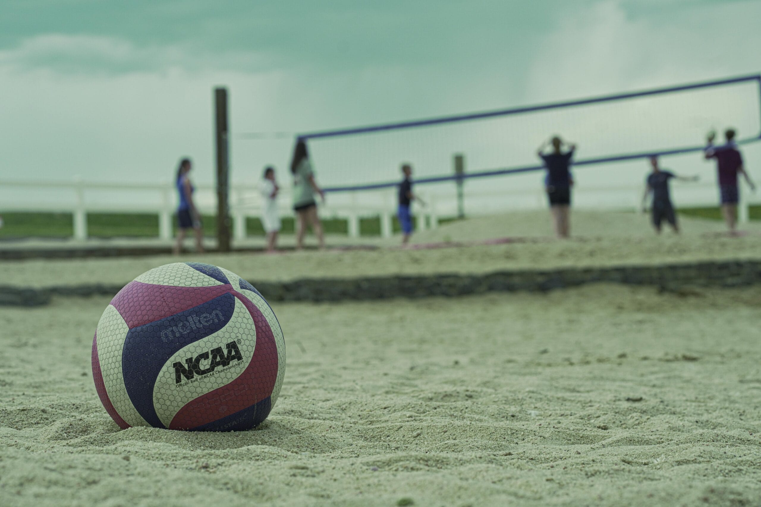 A sand volleyball game in Aurora, Colorado, with a focus on a volleyball.