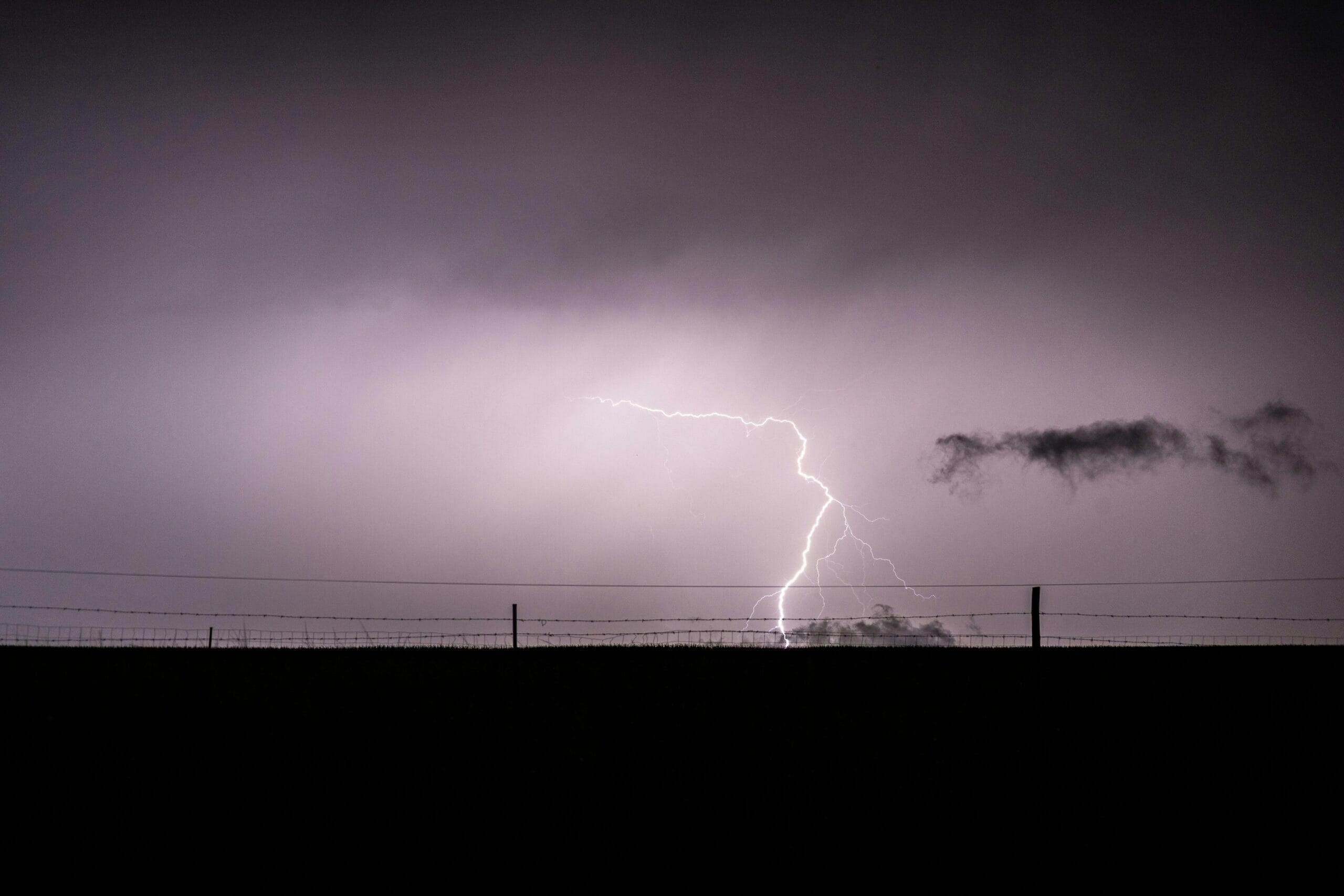 Dramatic lightning bolt over a field in Ephangweni, KwaZulu-Natal, South Africa.