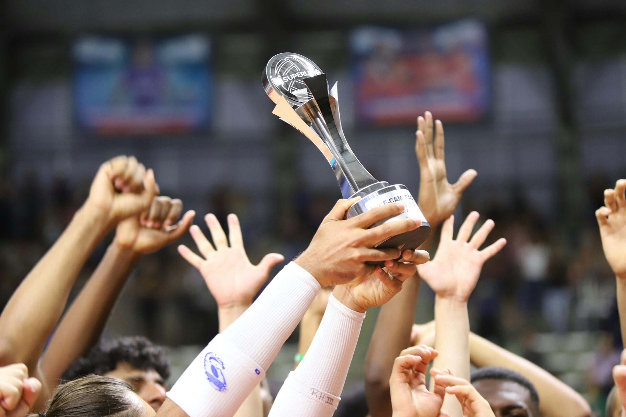 Group holds trophy in celebration, showcasing unity and achievement.