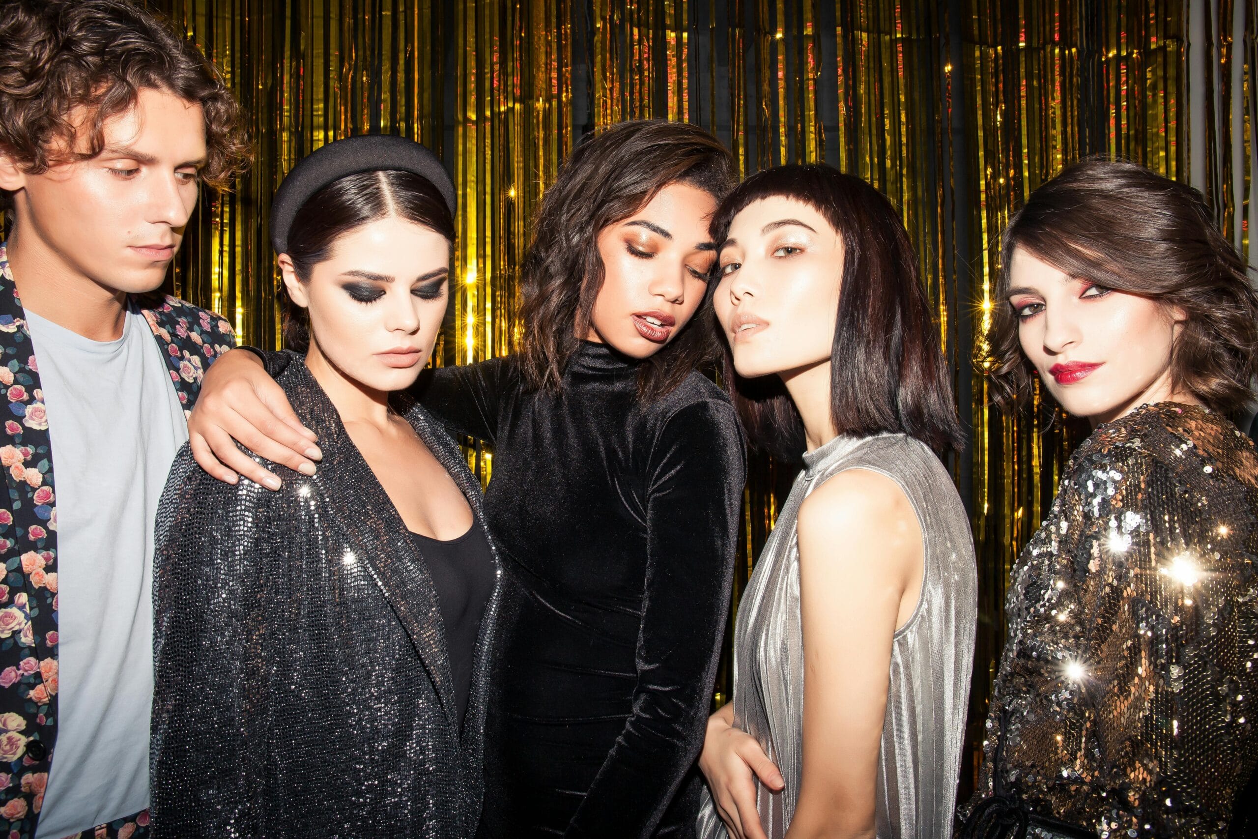 A stylish group reveling in a vibrant nightlife setting, embracing fashion and festive vibes.